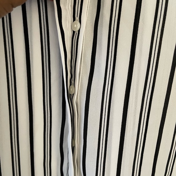 This blouse is white with black vertical stripes.  It’s a little bit sheer. - Picture 3 of 5